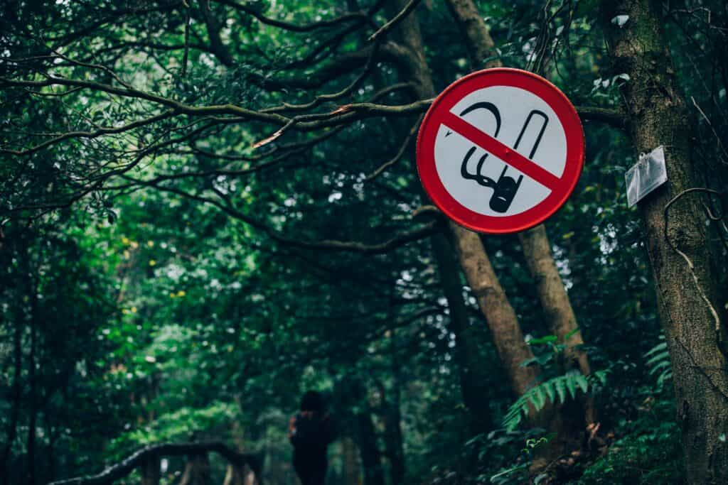 No smoking sign in forest.