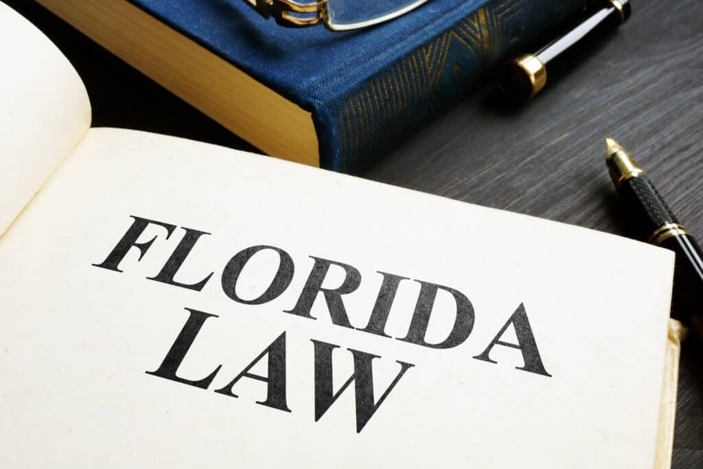 Open book with Florida law on a desk.