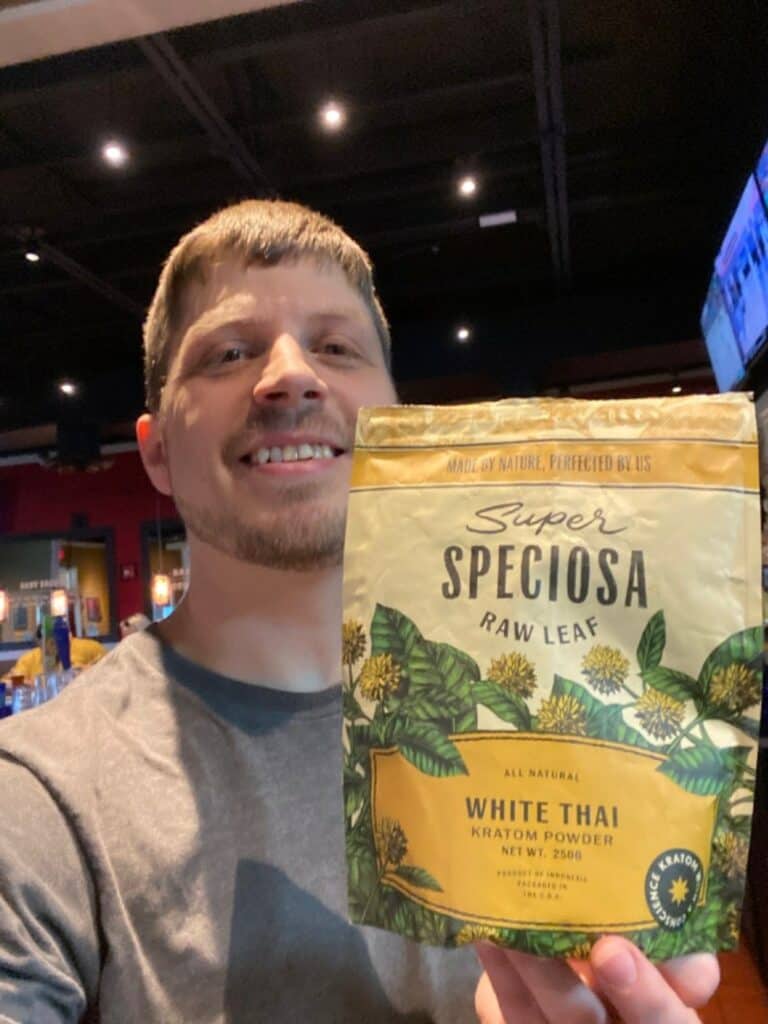 Young man with Super Speciosa White Thai lab tested kratom powder, selfie.