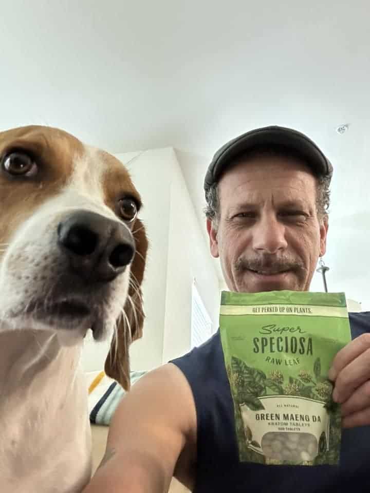 Man and dog with Super Speciosa's green maeng da powder product, very satisfied kratom customer
