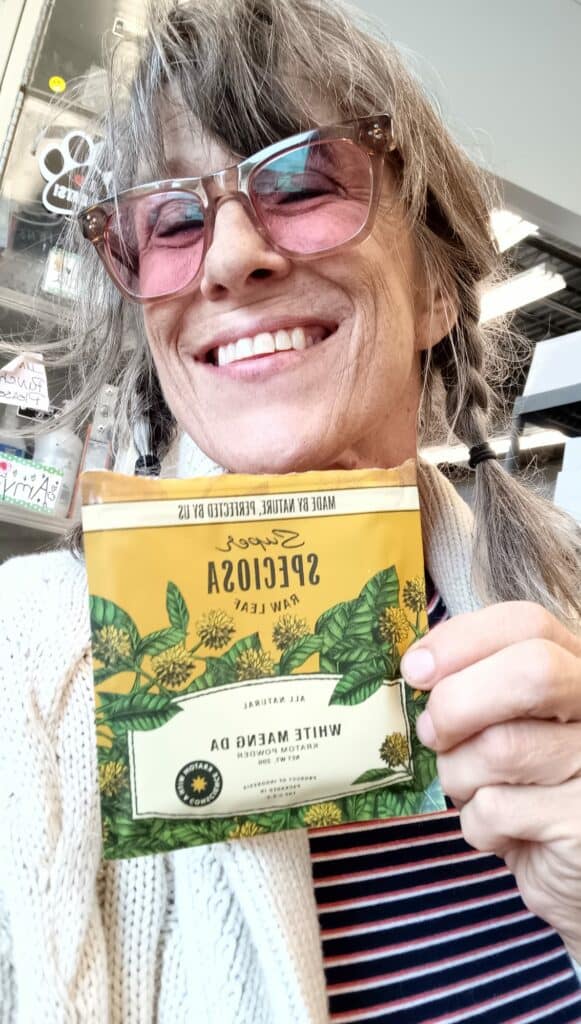 Woman with Super Speciosa's White Maeng Da kratom powder, one of our many satisfied customers!