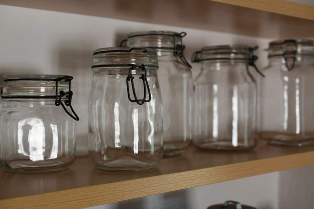 Mason jars sitting in a shelf, perfect storage for kratom powder.
