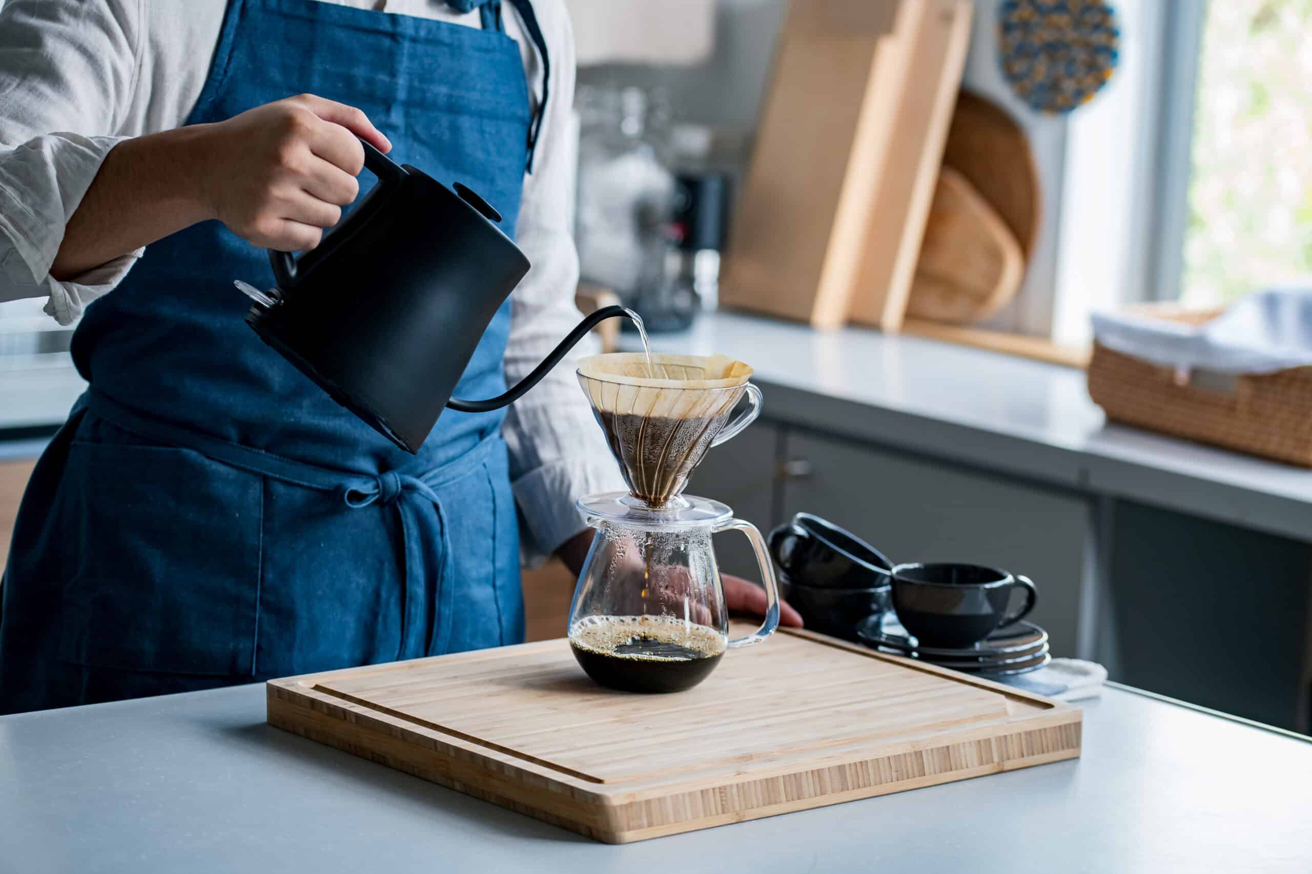 Man making coffee in the kitchen. Delicious coffee image. Coffee or caffeine can help potentiate kratom's effects.