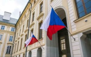 National flags of the Czech Republic on the facade of the government building in Prague, where Czech Republic’s kratom regulation took place.